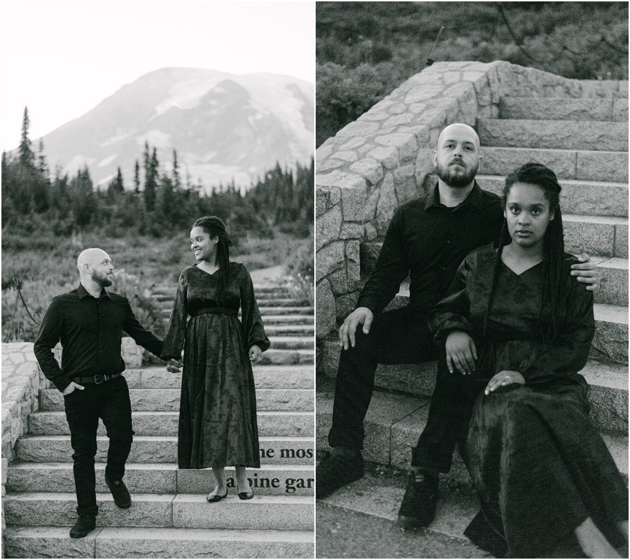 Couple posing for their engagement photos in all black on a concrete staircase at Mt Rainier.