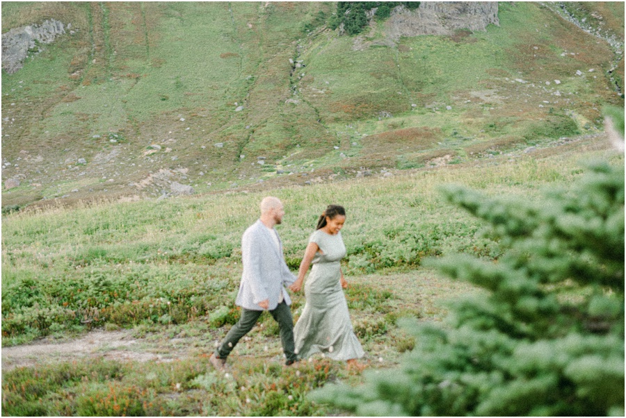 Couple walking across the screen holding hands at their Mt Rainier Engagement Session