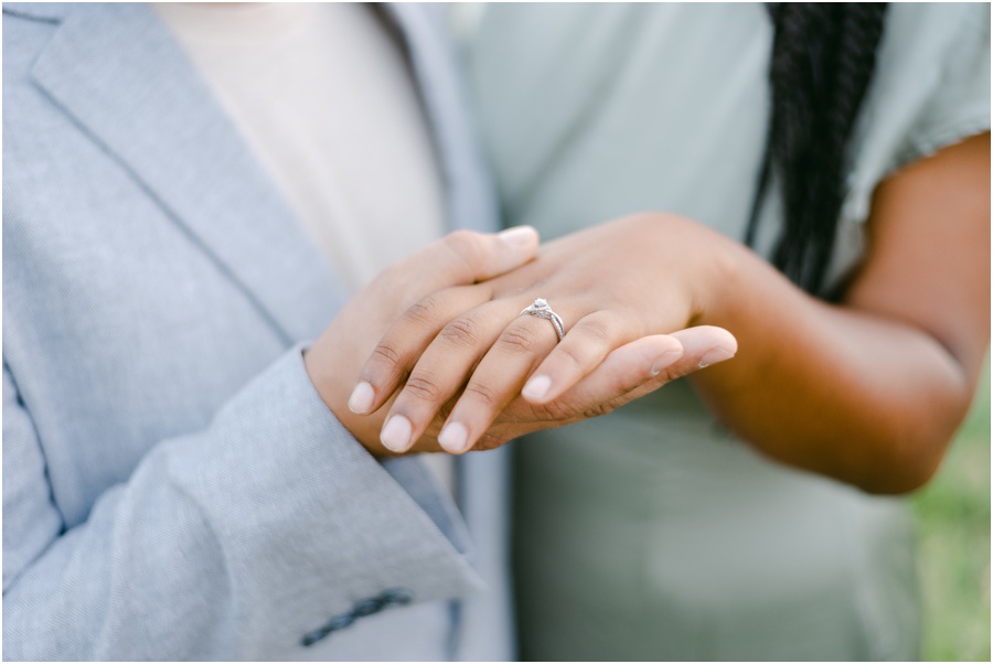 Couple holding hands showing the women's engagement ring.