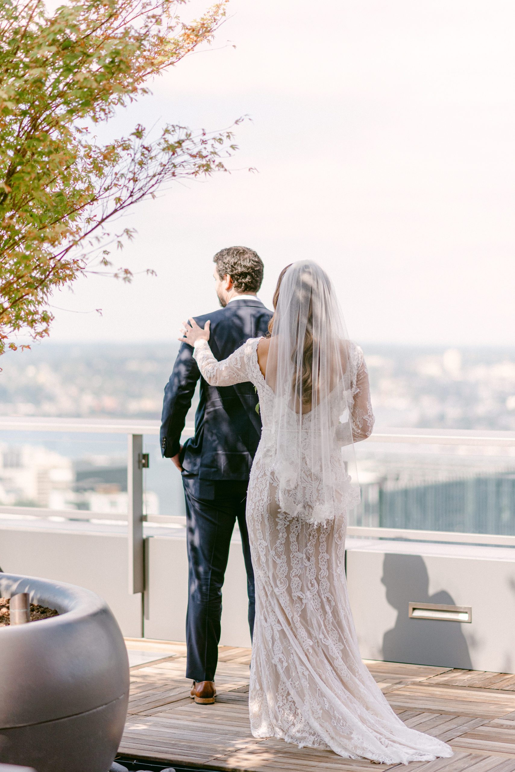 Seattle Washington, The Sound Hotel. First look with couple on their wedding day. Downtown Seattle in the Background. Bride reaching for her soon-to-be husband.